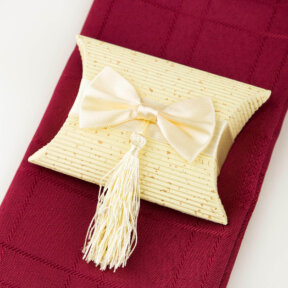 ivory pillow box with satin bow and tassel